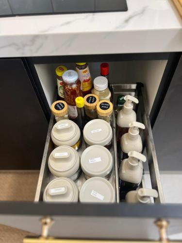 a drawer of a refrigerator filled with condiments at Amliza homestay in Cyberjaya