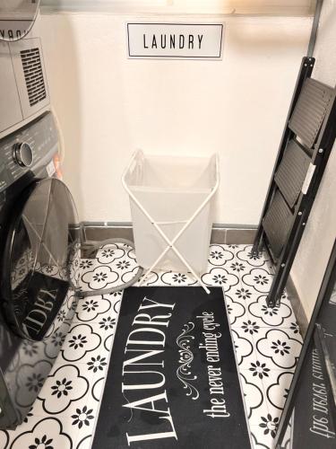 a laundry room with a laundry sign on the floor at Amliza homestay in Cyberjaya