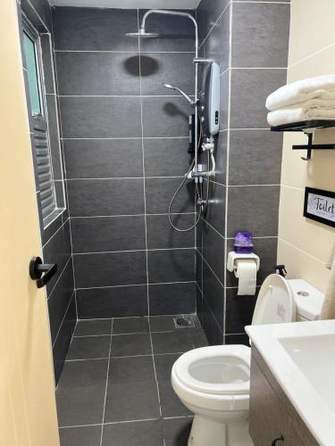 a bathroom with a shower and a toilet at Amliza homestay in Cyberjaya
