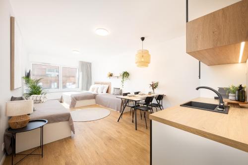 a kitchen and living room with a couch and a table at Internesto Brno Urban in Brno