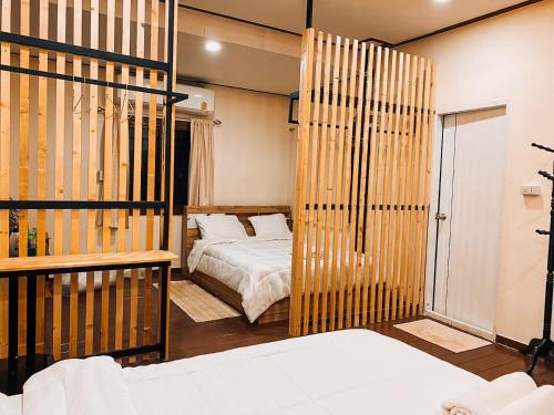 a bedroom with a bed and atained at บ้านชมธาร บ้านสวนสราญชล in Ban Plai Nam (2)