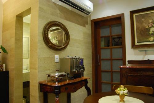 a room with a table with a coffee maker and a mirror at Pousada Bahia Pelô in Salvador