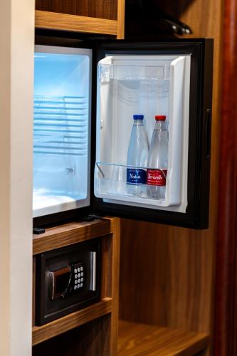 an open refrigerator with two bottles of soda in it at Hotel Bellavista in Marina di Varcaturo