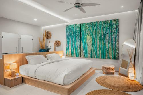 a bedroom with a bed and a painting on the wall at Beachfront Secret Tides Villa Tierra in Koh Samui 