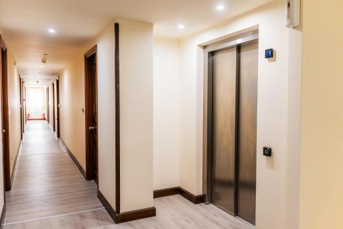 a corridor of an office building with a long hallway at Fiori Hotel in Gouvia