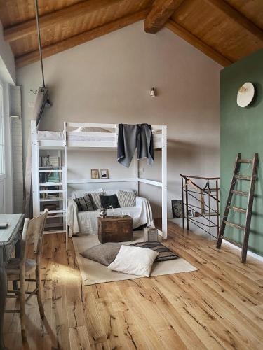 a room with bunk beds and a table and a desk at Bi&Babette in Cocconato