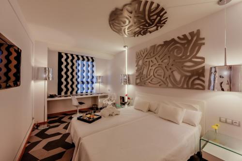a bedroom with a white bed in a room at Evenia Rossello in Barcelona