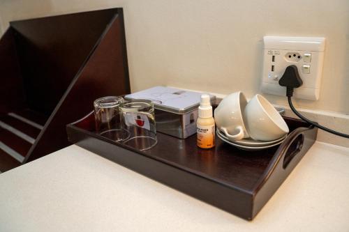 a black box with a charger and a telephone at Sunriver Kalahari Lodge Riverside stay in Upington in Upington