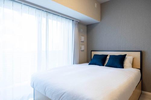 En eller flere senge i et værelse på MAT Ryogoku