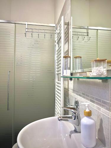 a bathroom with a sink and a glass shower at CQ Rooms Verona in Verona