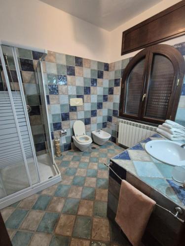 a bathroom with a toilet and a sink and a shower at La Cicogna in Agerola