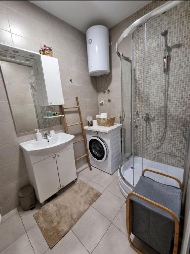 a bathroom with a sink and a washing machine at Sunset in Teslić