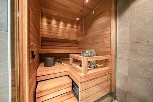 a sauna with a wooden paneled wall at Ski Chalet C10 Levi Center incl 2 ski passes by Aavalevi in Levi
