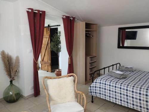 une chambre avec un lit, une chaise et une fenêtre dans l'établissement Détente sous le figuier, à La Garde