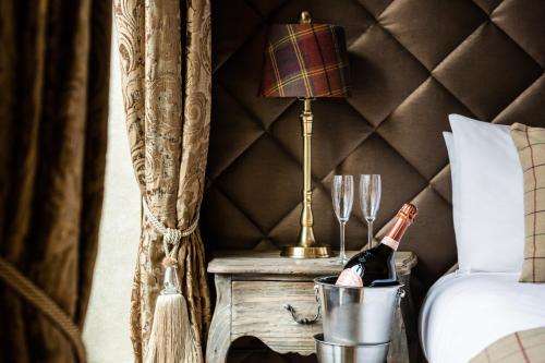 a bottle of champagne in a bucket next to a bed at The Shankly Hotel in Liverpool