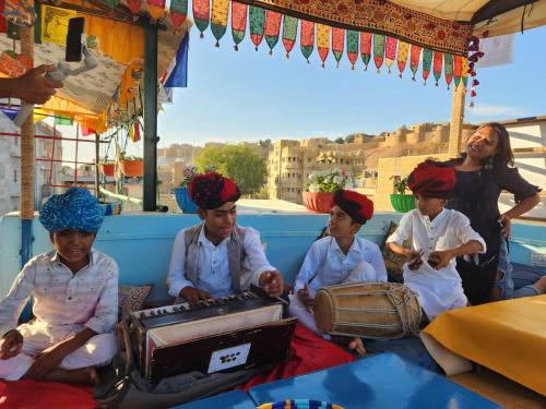 a group of children wearing turbans sitting in a bus at Blue Eye Hostel in Jaisalmer