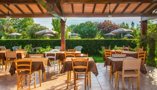 an outdoor restaurant with tables and chairs and umbrellas at B&B Da Pio in Pietrasanta