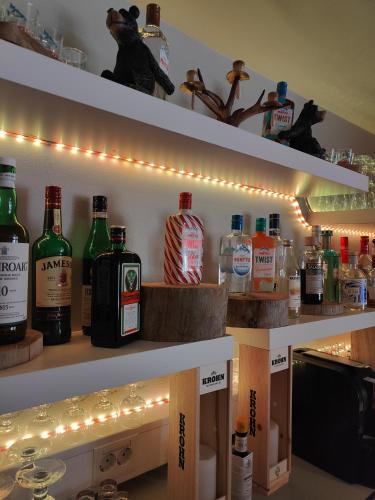 a shelf with bottles of alcohol and lights on it at Hotel Karhu in Sodankylä