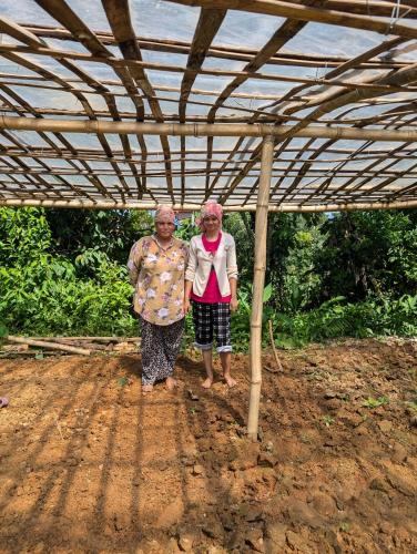 two older women walking under a metal roof at Indralok Hotel and Sky Garden in Deorāli