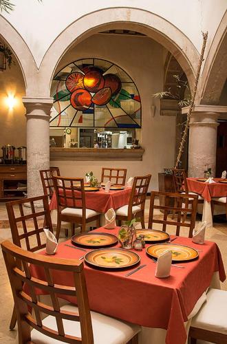 a table with plates of food on it in a restaurant at Hostal de La Monja in Durango