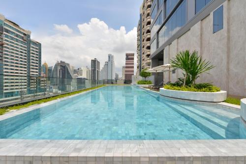 a swimming pool on the roof of a building at GM Estate Hotel and Executive Apartments Sukhumvit 20 in Bangkok