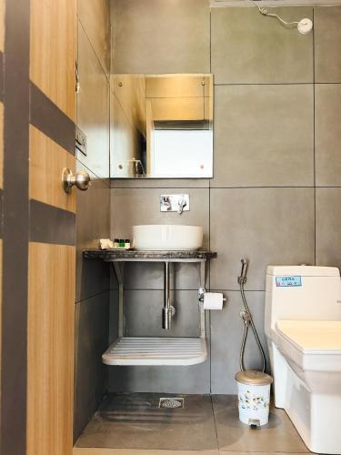 a bathroom with a sink and a toilet at Bir Valley Retreat in Bīr