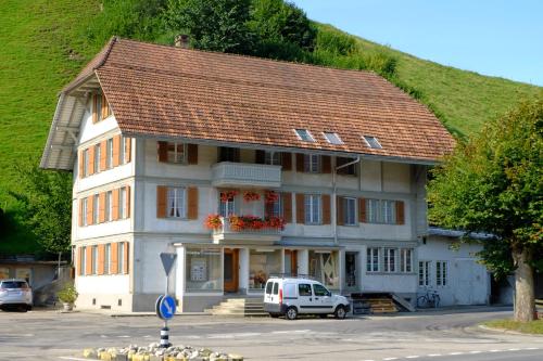 a large white building with a red roof at Ferienwohnung in Wasen