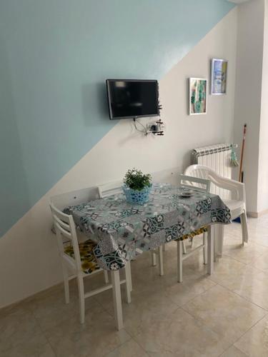 a dining room table and chairs with a table and a tv at Case Vacanza Da Silvì in Agropoli
