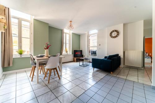 un salon avec une table et un canapé dans l'établissement Le Beaumont - Barbieux - 3 lits - Wifi - Parking - Terrasse privé, à Roubaix