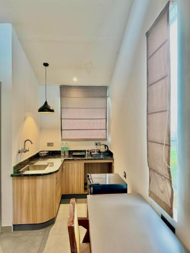 a kitchen with a sink and a table in a room at Bir Valley Retreat in Bīr