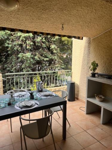 Cette chambre dispose d'un balcon avec une table et des chaises. dans l'établissement Le SAYULA, à Bandol
