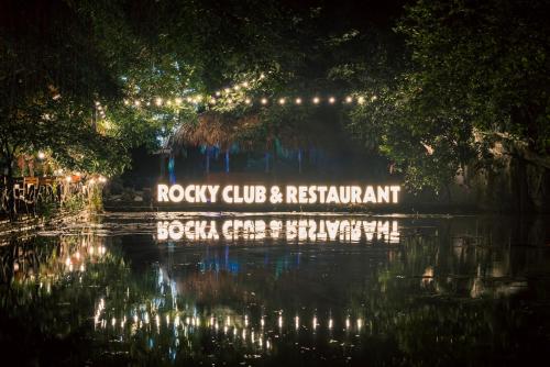a sign in the middle of a pond with lights at Tam Coc Rocky Bungalow in Ninh Binh