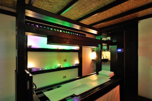 a room with a aquarium with green lights at Hotel Benessere Villa Fiorita in Colfiorito