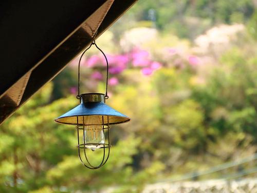 a light hanging from the side of a building at Oyado Katsu in Nagiso