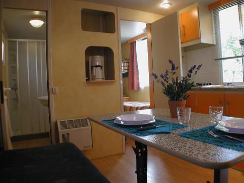 a kitchen with a table with plates on it at Camping Village Torre Pendente in Pisa