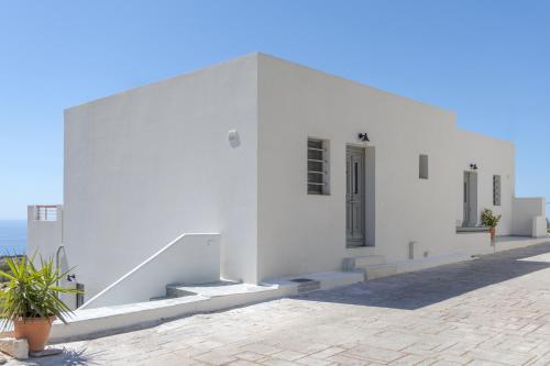 a white building with stairs on the side of it at South Akro in Míthoi