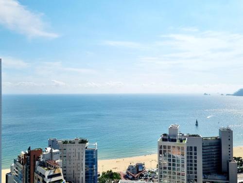 a view of a beach and buildings and the ocean at D OV Haeundae Hotel in Busan