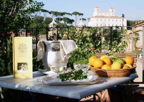 a table with a basket of fruit and a juicer at Hotel Mozart in Rome