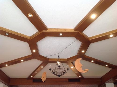 a coffered ceiling with a chandelier hanging from it at Landhotel Krone in Oberreute