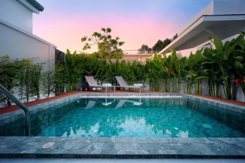 a swimming pool in the backyard of a house at Barringtonia pool villa in Phuket Town