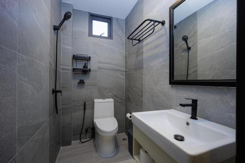 a bathroom with a sink and a toilet and a mirror at Barringtonia pool villa in Phuket Town