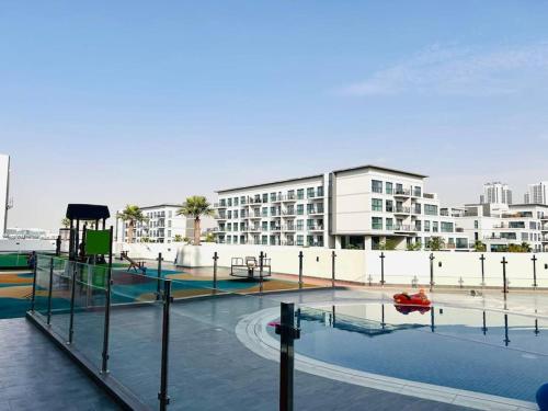 a playground in front of a large building at Studio entièrement meublé in Dubai