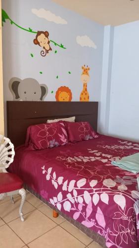 a bedroom with a bed with a purple comforter at La esquina in Monterrey