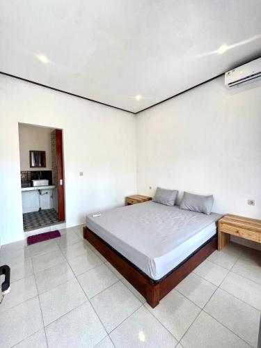 a bedroom with a large bed in a room at Isirela in Kuta Lombok