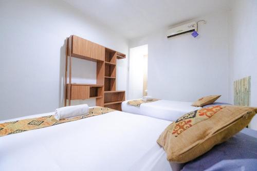 Postel nebo postele na pokoji v ubytování Apartmen Kak Okoh