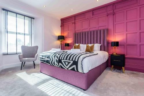 a purple bedroom with a bed and a chair at Elderberry Hall The Ultimate Family Reunion HQ in Fishburn