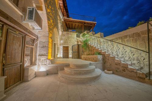 a stone building with stairs and a stair case at Gamirasu Village House in Nevsehir
