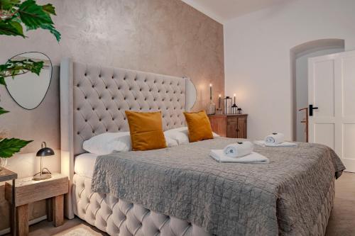 a bedroom with a large bed with two towels on it at Sting Old Town Ostrava in Ostrava