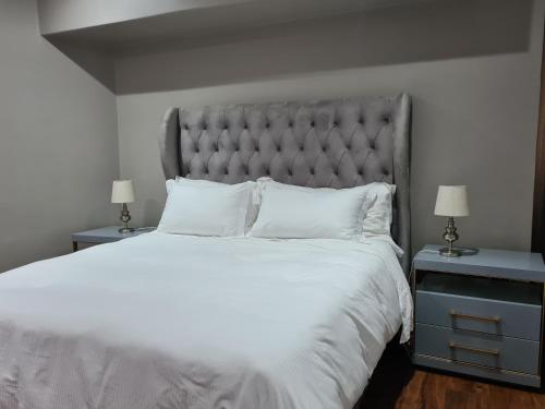 a bedroom with a large bed with white sheets and pillows at Beach House Margate in Margate