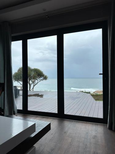 a room with a large window with a view of the ocean at Beach House Margate in Margate